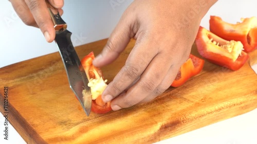 Women Slicing Bell Peppers on a Wooden  Board