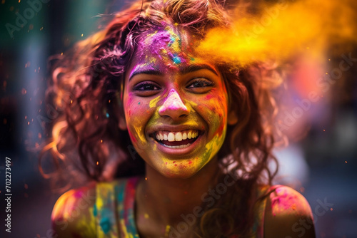 Portrait of young woman in colorful powder on indian street, Holi festival