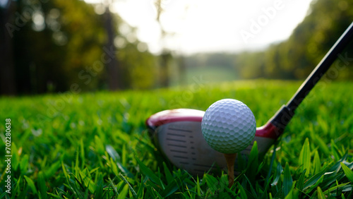 Golf ball and golf club in beautiful golf course at sunset background