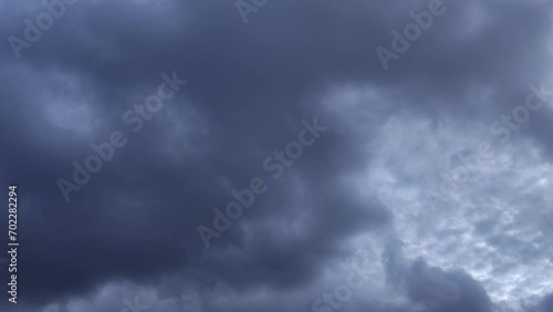 Dark sky that covered blue sky begins to move away and spherical clouds are seen