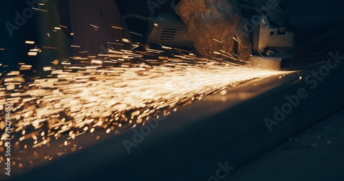Fototapeta Naklejka Na Ścianę i Meble -  Grinding Metal Sparks Steel Cutting At Industrial Workshop