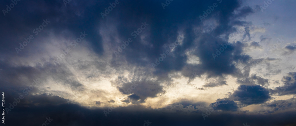 Dark ominous sky with blue clouds during sunrise
