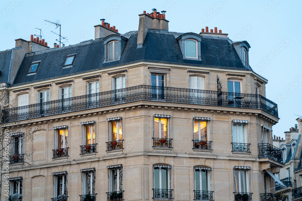 Obraz premium On the streets of Paris concept. Traditional classic Parisian beige facade with grey roof. 