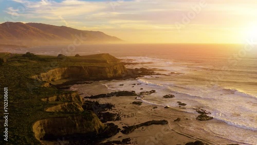 Coastline landscape at sunset with big waves. Aerial view of California Coastline along the Big Sur. 