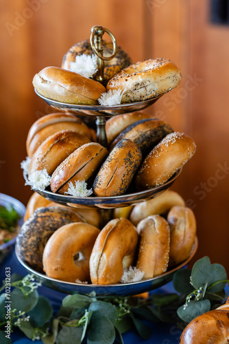 Canvas-taulu closeup of assorted bagels on three tiered tray at catered luncheon
