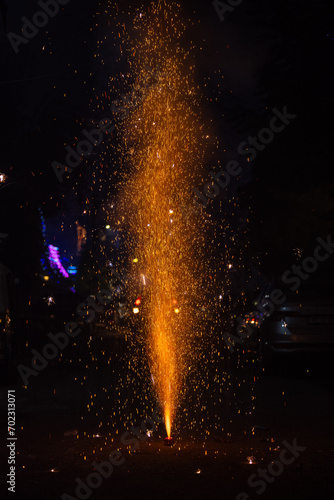 Flower Pots or Anar fireworks burning with sparkle during the festival of diwali in India.