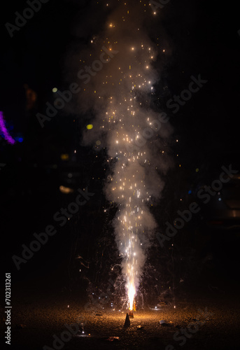 Flower Pots or Anar fireworks burning with sparkle during the festival of diwali in India.