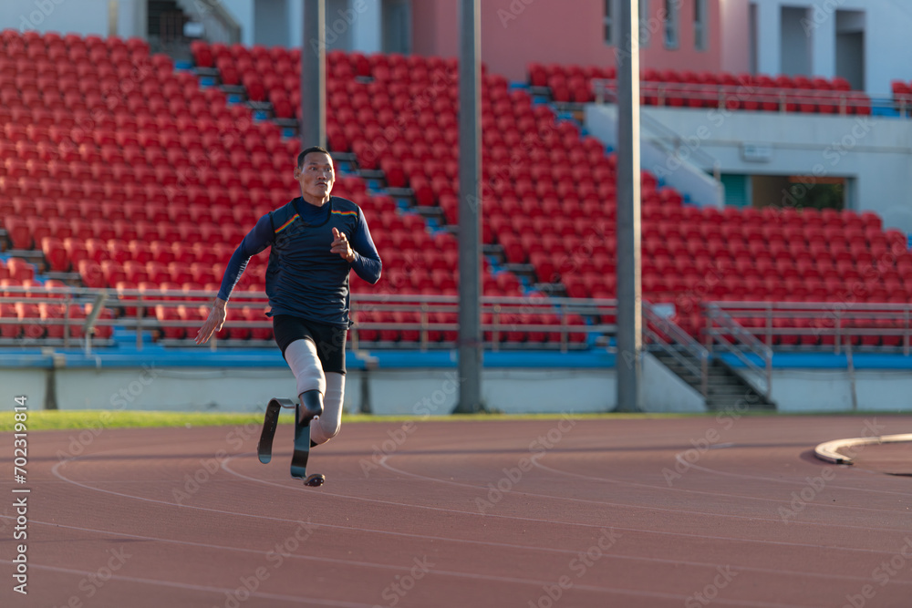 Fototapeta premium Athletes with disabilities who utilize running blades for short distances. Run down the running track.