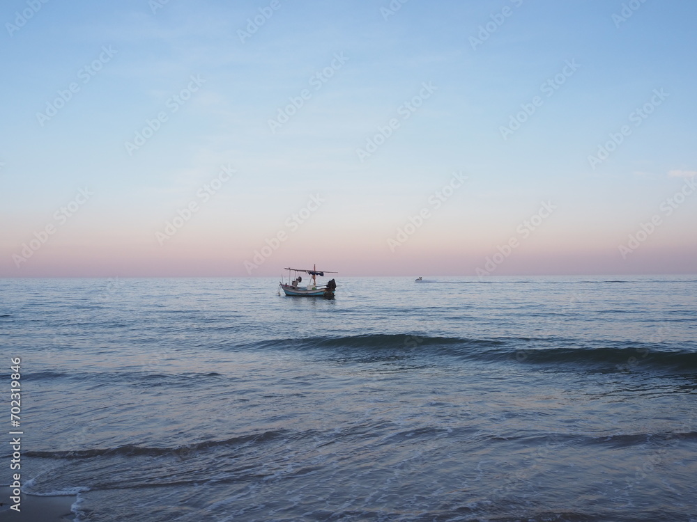 A fishing boat is moored in the middle of the sea.