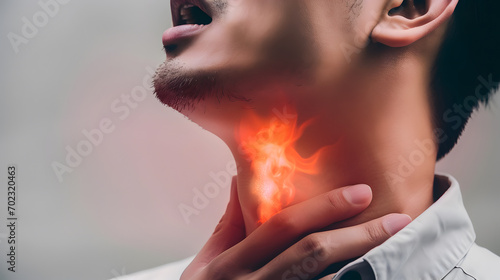 Flame at neck of a man. Concept of sore throat, pharyngitis, laryngitis, thyroiditis, choking photo