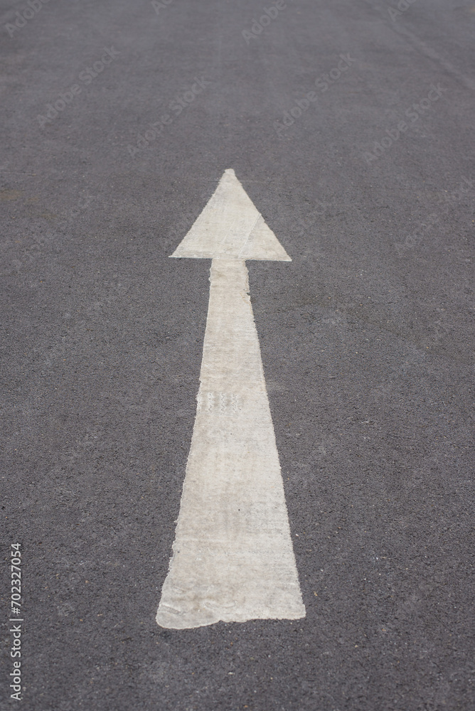 white sign and arrow