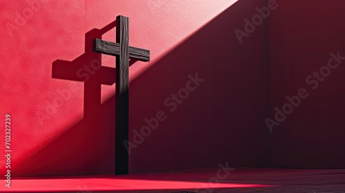  a cross sitting in front of a red wall with a shadow of a cross on the side of the wall.