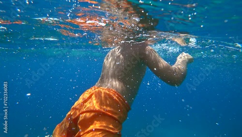 Kas, Turkey - 5th of September 2023: 4K Chubby boy tumbling backwards underwater
 photo