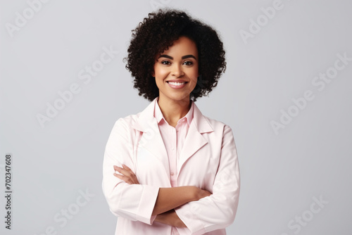 Young afro american doctor woman over isolated background happy face smiling with crossed arms looking at the camera. Positive person