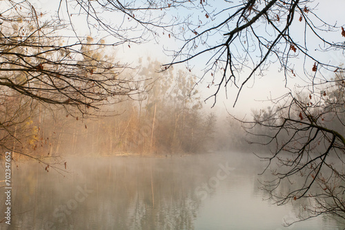 fog over the lake  cold morning  late autumn in park