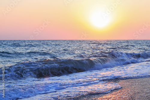 Sunrise on the beach. Sea waves. Seaside under a rough sky. sandy beach near sea with waves at sunset. Summer vacation. Vacation travel holiday banner. Beautiful cloudscape over the sea. Sunrise shot
