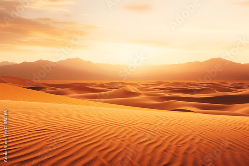 Golden sand ripples at sunset. The sun sets behind the orange sandy mountains, creating an atmosphere of peace, background with copy space
