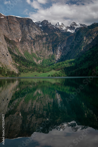 Steep mountain cliffs at lake Obersee reflecting on water surface, Berchtesgaden Bavaria.