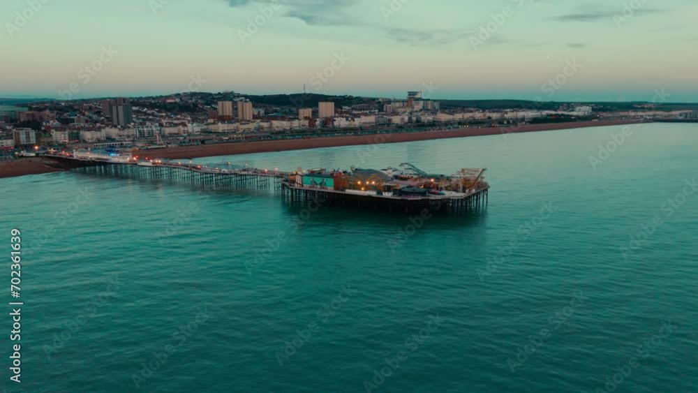 Pier and fair ground in Brighton by the beach aerial drone with waves and sea Pier and fair ground in Brighton by the beach aerial drone with waves and sea