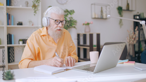 Wallpaper Mural Senior man converses with his online tutor, dedicatedly studying at home as a mature student Torontodigital.ca