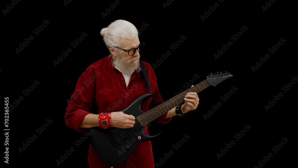 Man in his 60s plays the electric guitar, embodying the spirit of forever young and rock and roll Man in his 60s plays the electric guitar, embodying the spirit of forever young and rock and roll