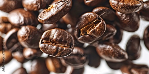 Close-up shot of isolated coffee beans against a white backdrop.
