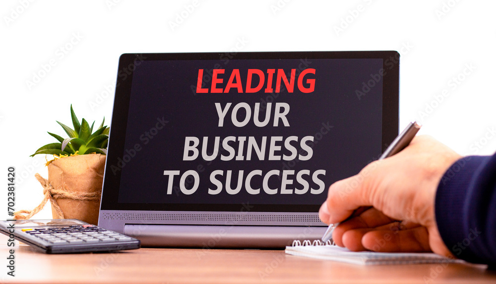 Leading your business to success symbol. Concept words Leading your business to success on beautiful black tablet. Beautiful white background. Leading your business to success concept. Copy space Leading your business to success symbol. Concept words Leading your business to success on beautiful black tablet. Beautiful white background. Leading your business to success concept. Copy space