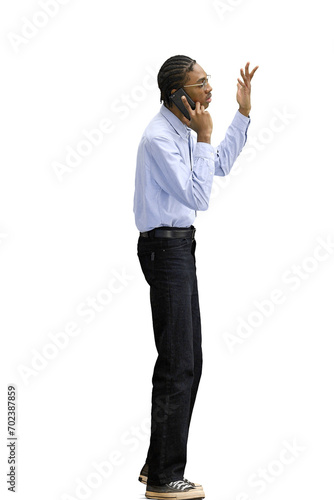 A man in a gray shirt, on a white background, full-length, with a phone