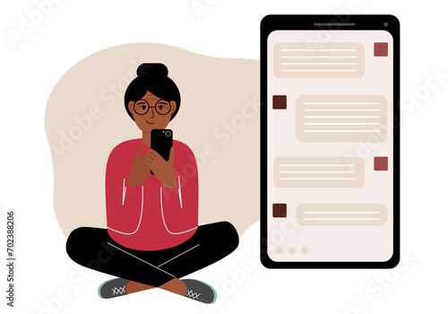A woman sits and holds a phone. The correspondence is visible on the screen. Concept of chat, sms, service, technical support.