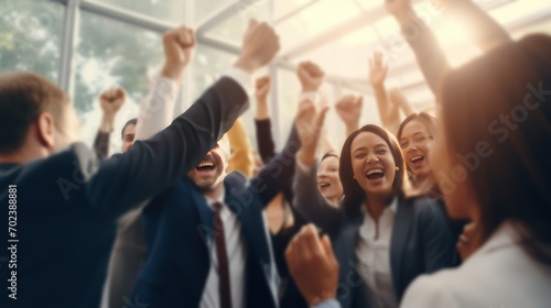 Blurred image of a diverse business team happily celebrating success and having fun together, high-fiving and cheering. photo
