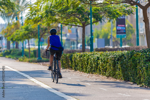 Wallpaper Mural athlete on a bicycle rides in the park Torontodigital.ca