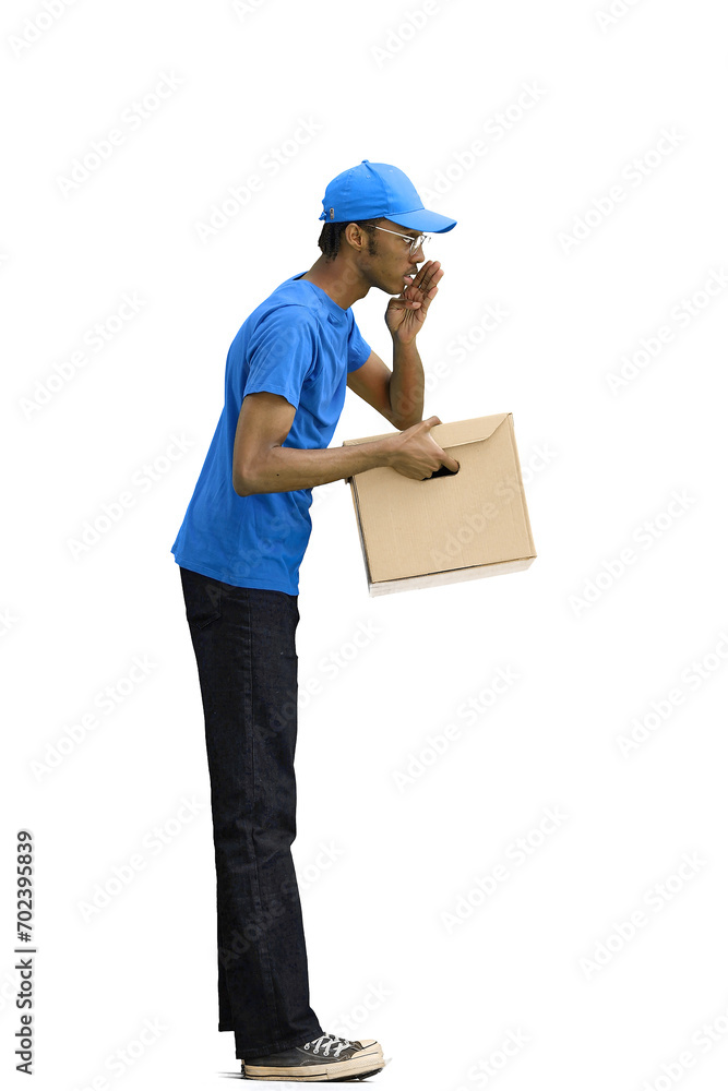 A male deliveryman, on a white background, full-length, with a box, tells a secret A male deliveryman, on a white background, full-length, with a box, tells a secret
