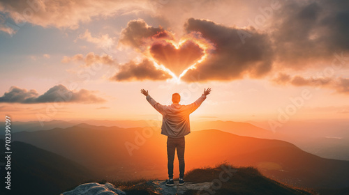  Man praying at sunset Red heart shaped clouds at sunset. Beautiful love background with copy space. Valentine's Day concept.