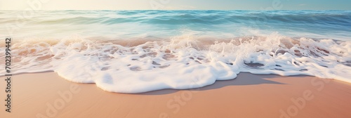 A close-up shot of gentle waves caressing the shore on a pristine sandy beach © PinkiePie