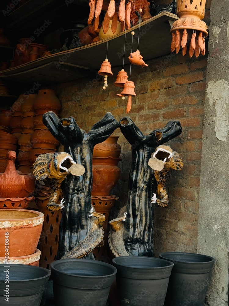 Inside a pottery workshop and shop in Kathmandu, Nepal, where various clay creations, including animals and pottery items, come to life.