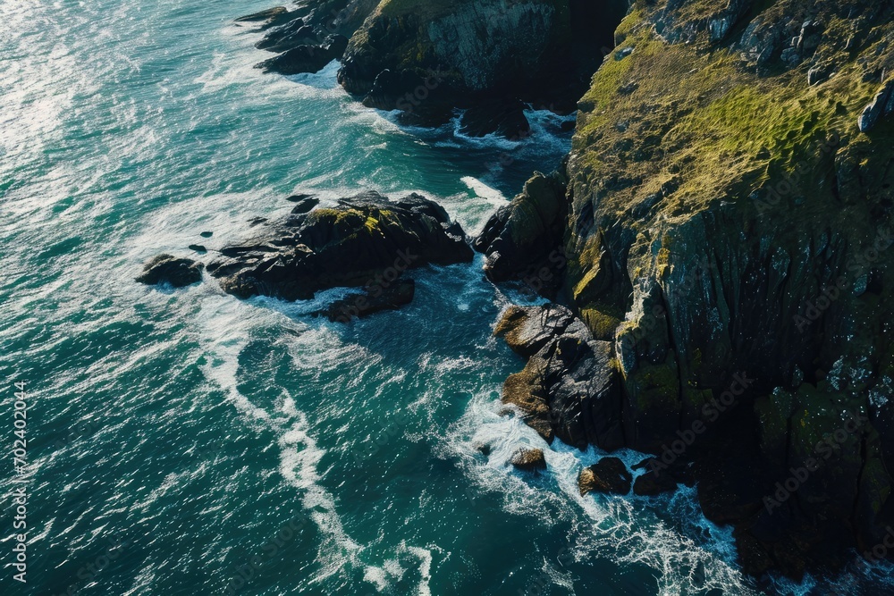 A rugged coastline adorned with towering cliffs, battered by the relentless crashing of waves against the rocky shore, where nature's water resources meet the vast expanse of the ocean