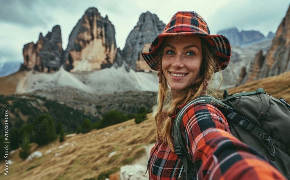 Alpine Adventure: In the Italian Alps, a smiling native woman with a backpack takes a selfie near the Dolomites, portraying the joy and cultural essence of her travel adventure.

