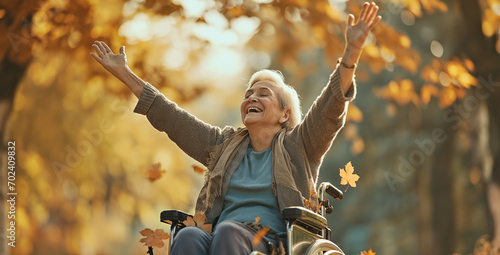 Happy senior woman on a wheelchair - diversity and inclusion concept - Praising the Lord - Praying for a miricale and healing - Happiness and independence despite disability photo
