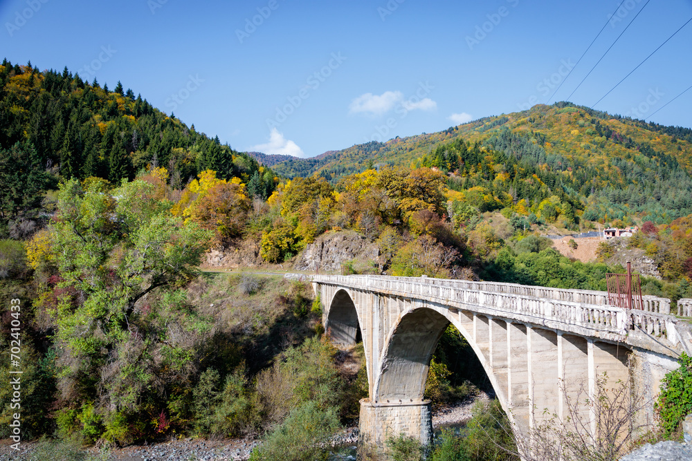 Majestic Tall Bridge Over the River in the Mountainous Terrain