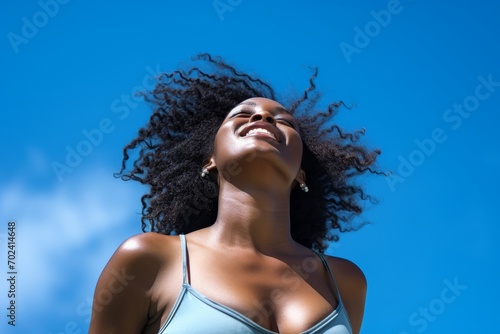 Stock photography of a black African American woman. Mind. Launching, blue sky background photo