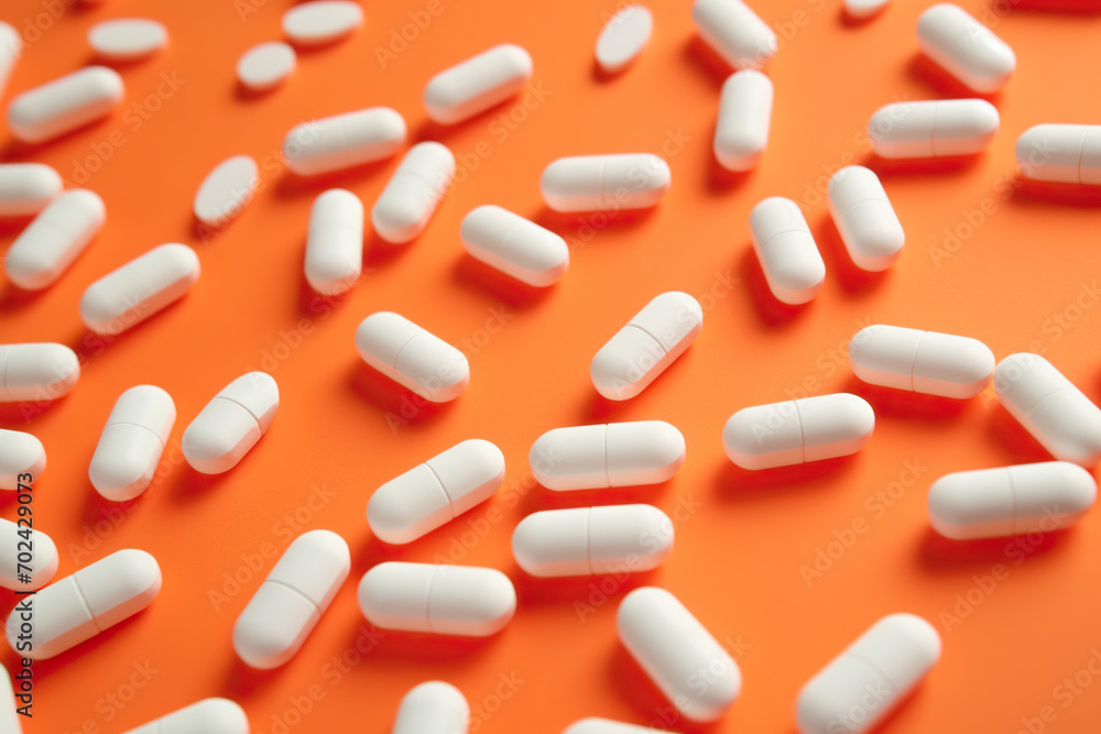 A Scattering of White Pills on an Orange Surface A Scattering of White Pills on an Orange Surface