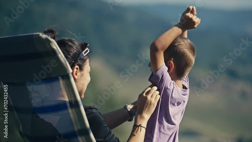 Teenage Girl Playing With Her Young Cousin By Tickling Him Under the Armpit photo