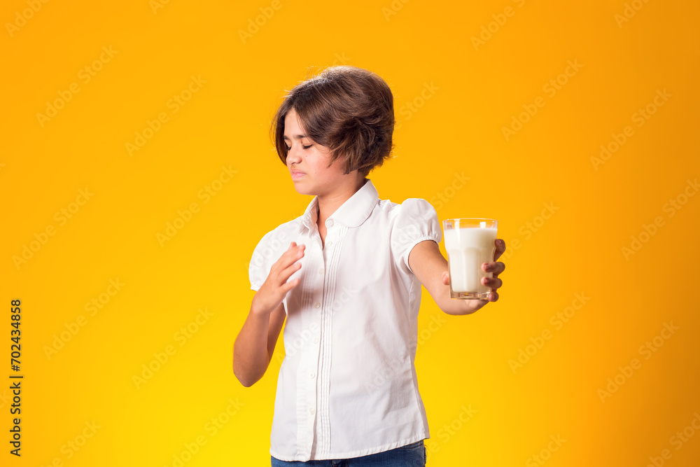 Girl with glass of milk doesn't like it. Dairy Intolerant person. Lactose intolerance, health care concept. Girl with glass of milk doesn't like it. Dairy Intolerant person. Lactose intolerance, health care concept.