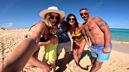 Happy group of friends, family on summer vacation. People having fun on the beach. 