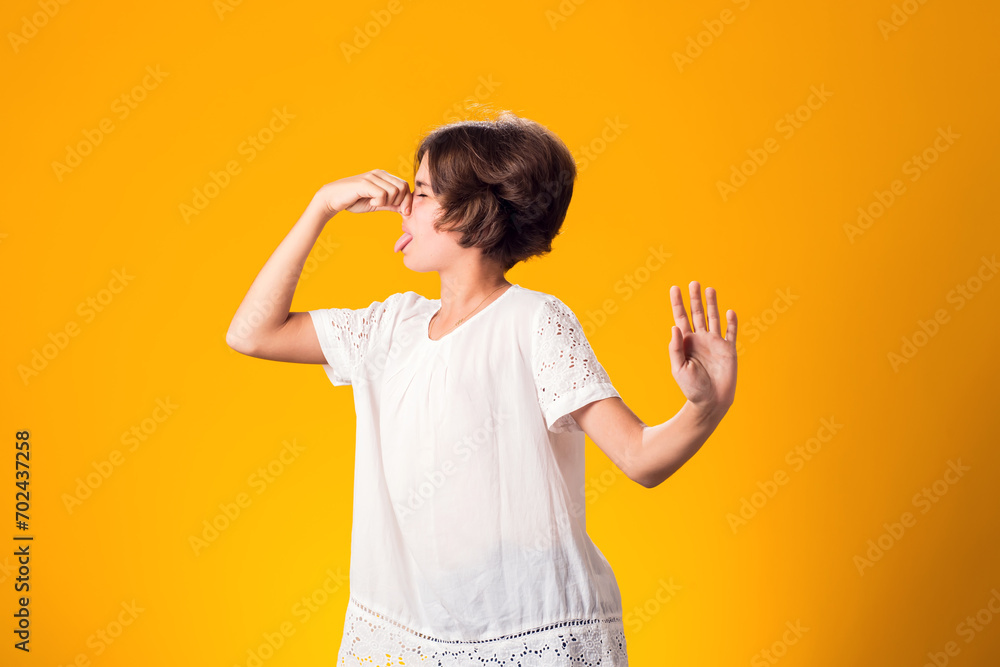 Kid girl feeling bad and dislike smell and hold nose from funny odor - obrazy, fototapety, plakaty 
