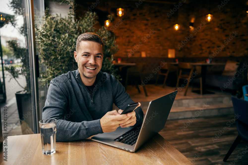 Portrait of a social media marketer using phone in working friendly cafe. Portrait of a social media marketer using phone in working friendly cafe.