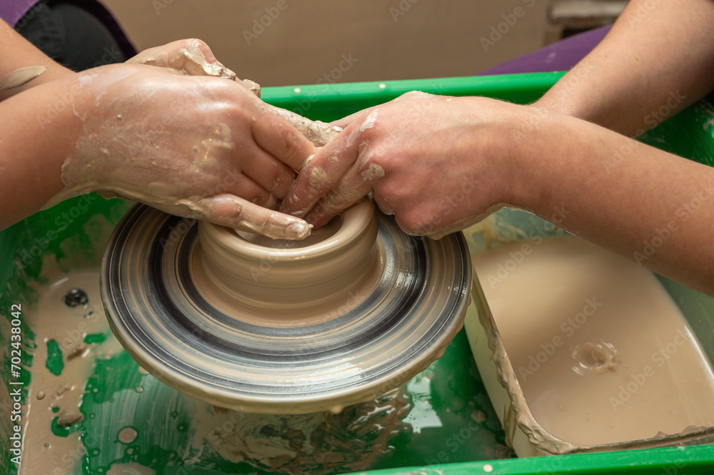 Clay, pottery or hands in designer workshop working on an artistic cup or mug mold in small business studio. Hand of creative artist or worker manufacturing handicraft products in sculpture Clay, pottery or hands in designer workshop working on an artistic cup or mug mold in small business studio. Hand of creative artist or worker manufacturing handicraft products in sculpture