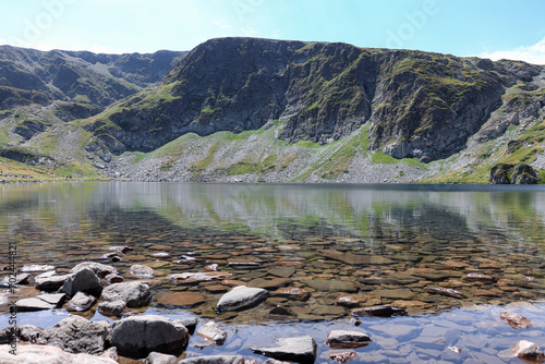 The Kidney (Babreka) Lake view of the water as stones cover the ground seen through the clear lake water at Seven Rila Lakes photo