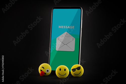 Mobile phone with smiley faces and emojis. photo