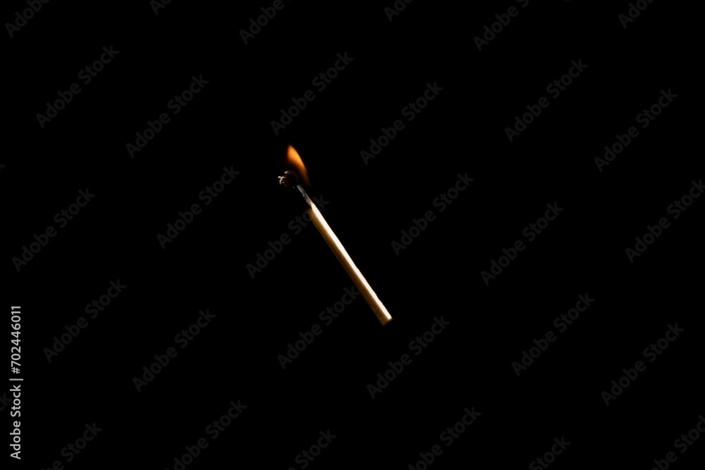 Lit falling match on a black background. Lit falling match on a black background.